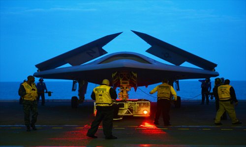 This photo released by the US navy on Monday shows an X-47B Unmanned Combat Air System (UCAS) demonstrator being towed into the hangar bay of the aircraft carrier USS George H. W. Bush (CVN 77) during operations in the Atlantic Ocean. The George H. W. Bush is scheduled to be the first aircraft carrier to catapult-launch an unmanned aircraft from its flight deck. Photo: AFP