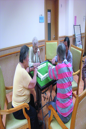 Senior citizens play mahjong at the senior center.