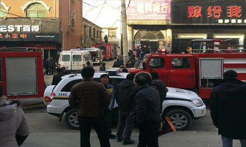 Rescue vehicles wait on the fire accident site in Lankao county, Central China's Henan Province, January 4, 2013. A fire broke out in a residential building in Chengguan township of Lankao county at about 8:30 am on Friday and was extinguished about two hours later. Four children were killed on the spot, three died on the way to hospital and one other is still being treated in the hospital. An initial investigation showed that the accident site was an adoptive family where the children killed and injured lived in. The cause of the fire is still under investigation. Photo: Xinhua