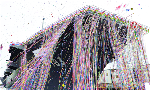 Japan's newest warship is covered with decoration tape and confetti as it is pictured during a launch ceremony in Yokohama on Tuesday. Photo: AFP