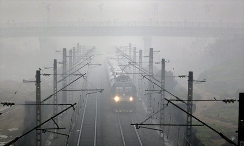 A train plows through dense fog and rain in Wuhan, Hubei Province, on Tuesday. The city has been shrouded in overcast skies and fog since Tuesday. Photo: CFP