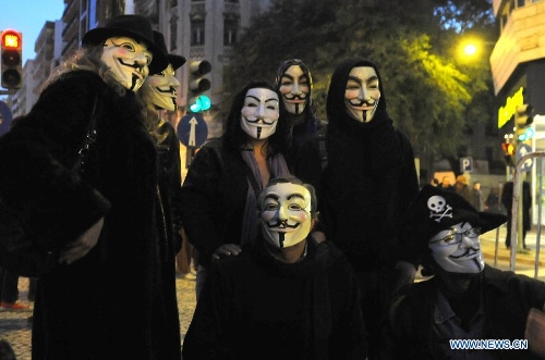 Protestors wearing masks take part in a protest in front of the Internatioanl Monetary Fund (IMF) Office in Lisbon, Portugal, on Jan, 30, 2013. Hundreds of Portuguese gathered in front of the Internatioanl Monetary Fund (IMF) Office in capital Lisbon, protesting against IMF's demand of more spending cuts by the Portuguese government and its drastic austerity policy. (Xinhua/Zhang Liyun)
