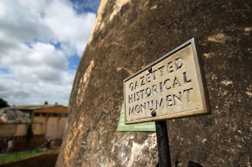 Photo taken on April 28, 2013 shows a historical monument plate at Fort Jesus in Mombasa, Kenya. The Fort, built by the Portuguese in 1593-1596 to the designs of Giovanni Battista Cairati to protect the port of Mombasa, is one of the most outstanding and well preserved examples of 16th Portuguese military fortification and a landmark in the history of this type of construction. The Fort's layout and form reflected the Renaissance ideal that perfect proportions and geometric harmony are to be found in the human body. The property covers an area of 2.36 hectares and includes the fort's moat and immediate surroundings. The UNESCO added the Fort Jesus to World Heritage List as a cultural site in 2011. (Xinhua/Meng Chenguang) 