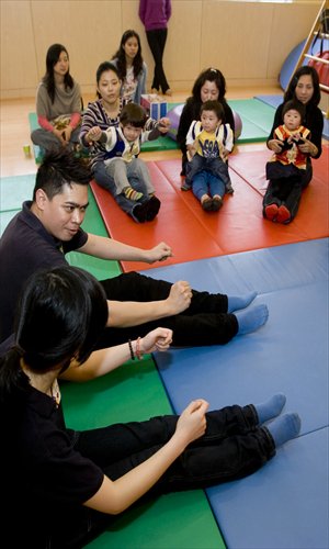 Parents play with their children at an early childhood education center in Shanghai. Photo: CFP