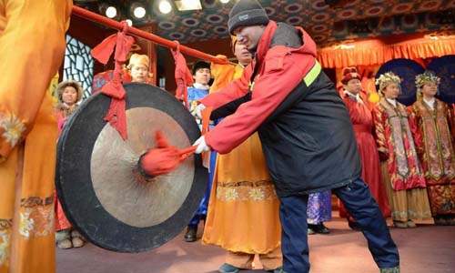 A representative of Beijing sanitation workers knocks a bell to inaugurate the 18th Honglou Temple Fair held at the Grand View Garden in Beijing, capital of China, Feb. 10, 2013. Various activities were held all over China on Sunday to celebrate the Spring Festival, marking the start of Chinese lunar Year of the snake. The Spring Festival falls on Feb. 10 this year. Photo: Xinhua