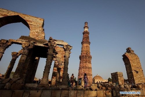 People visit the Qutab Minar in New Delhi, India, on April 5, 2013. Qutab Minar, a UNESCO World Heritage Site, is the tallest minaret in India. It is 75.56 metres high with a base a diameter of 14.3 metres, which narrows to 2.7 metres at the top storey. The minar is made of red sandstone and marble, and covered with intricate carvings. The construction of Qutab Minar started in 1193 by Qutub-ud-din Aibak and was completed by his inheritor Iltutmish. It is surrounded by several other ancient and medieval structures and ruins, collectively known as the Qutub complex, which attracts many visitors till now. (Xinhua/Zheng Huansong) 