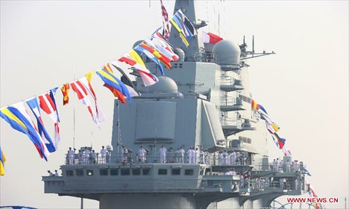 Navy soldiers stand on China's first aircraft carrier 