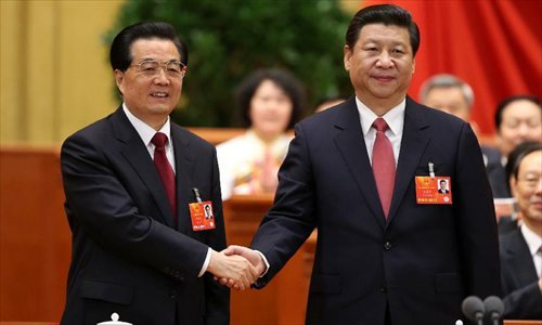Hu Jintao (left) congratulates Xi Jinping at the fourth plenary meeting of the first session of the 12th National People's Congress (NPC) in Beijing, capital of China, March 14, 2013. Xi was elected president of the People's Republic of China (PRC) and chairman of the Central Military Commission of the PRC at the NPC session here on Thursday. 