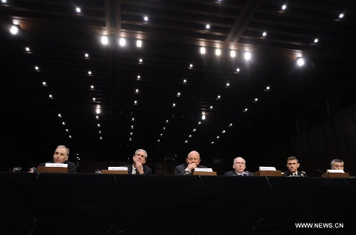 (L to R) National Counterterrorism Center Director Matthew Olsen, FBI Director Robert Mueller, Director of National Intelligence James Clapper, CIA Director John Brennan, Defense Intelligence Agency Director Michael Flynn, and Assistant Secretary of State for Intelligence and Research Philip Goldberg, testify before the Senate Select Intelligence Committee during a hearing on 