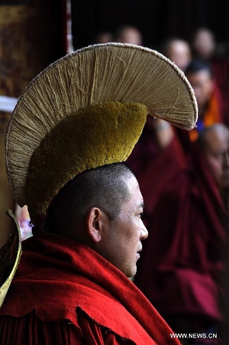 Losang Dargyai, who came out first in the test for Gexe Lharampa, the highest academic degree in Tibetan Buddhism studies, defends his dissertation at the Jokhang Temple in Lhasa, capital of southwest China's Tibet Autonomous Region, April 5, 2013. Eight laureates of Gexe Lharampa were awarded here on Friday after they passed tests and defended their dissertations. Gexe means knowledgeable and Lharampa is the highest among the four ranks in the Gexe system. (Xinhua/Chogo)