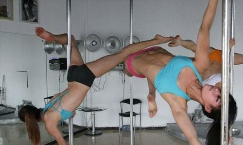 Three female Chinese national pole dancing team members, who will compete in the World Pole Dance Championships to be held in Zurich, Switzerland on November 10 training on Tuesday. This is the first open training session since the Chinese national pole dancing team was set up in Tianjin. The team consists of five women and two men on the main squad, along with six substitutes. 