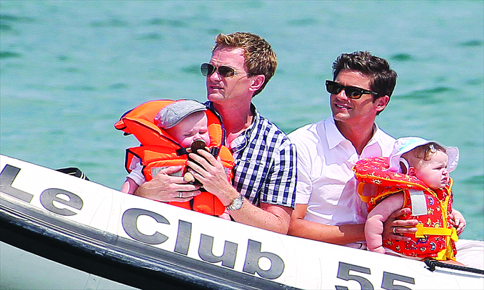 Neil Patrick Harris, an American actor, director and producer, and his partner David Burtka enjoy a holiday with their twins from a surrogate mother in St. Tropez, France, on August 4, 2011. Photo: IC