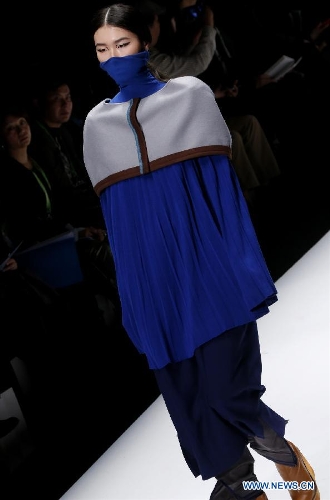 A model presents a creation designed by students from China Academy of Art during the 1st China Graduate Fashion Week in Beijing, capital of China, April 24, 2013. A total of 610 graduate students from 22 universities will present their designs during the five-day event which kicked off on Wednesday. (Xinhua/Li Mingfang)