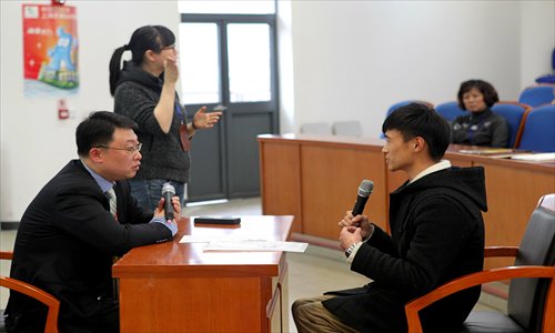 A student with a leg disability takes part in a mock job interview Tuesday as part of a training course in Songjiang district for disabled college graduates. The course, which was organized by the Shanghai Employment Service Center for the Disabled, invited Fortune 500 companies to analyze employment trends and career positioning for participants. Photo: Yang Hui/GT