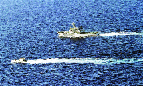A Taiwanese fishing boat (left) is chased by a Japanese coast guard vessel near the Diaoyu Islands in the East China Sea, as shown in this handout picture taken by the Japan Coast Guard Wednesday. Photo: AFP