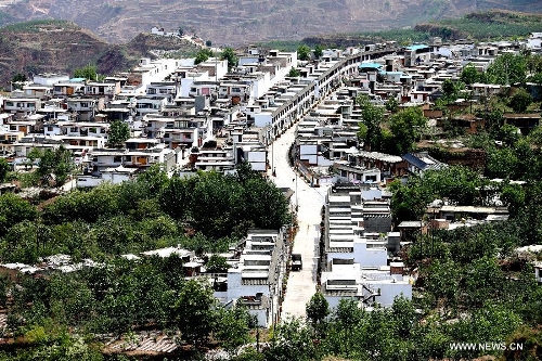 This bird eye view shows Jiangjiashan of Wudu District in Longnan City, northwest China's Gansu Province, May 9, 2013. In the year of 2008, a massive earthquake occurred in Gansu's neighbouring province Sichuan, and Longnan was also battered by the disaster. During the past five years, a total of 3,905 reconstruction projects have been carried out in the city, where over 240,000 households have their houses rebuilt, and hundreds of schools and hospitals have been set up as well. (Xinhua/Wang Yaodong) 