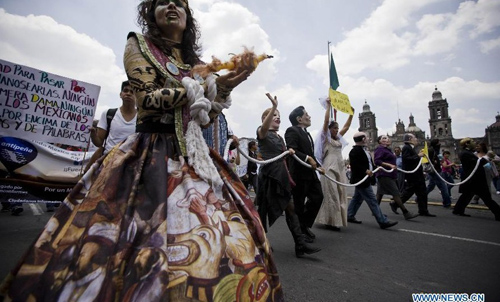 A woman wears a costume as she takes part in a demonstration protesting against the outcome of the July 1 general elections, in Mexico City, capital of Mexico, on July 22, 2012. Protesters marched to the Zocalo in downtown Mexico City. Thousands of demonstrators marched through Mexico City on Sunday to protest the outcome of the July 1 general elections, which declared Institutional Revolutionary Party (PRI) presidential candidate Enrique Pena Nieto the winner. Photo: Xinhua