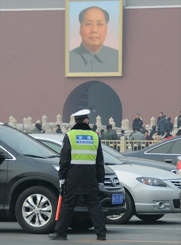 A security officer continues his patrol in front of Beijing's Tiananmen Square on Tuesday as the two sessions continue. Photo: CFP