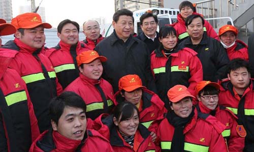 Xi Jinping (C), general secretary of the Communist Party of China (CPC) Central Committee and chairman of the CPC Central Military Commission, poses for a group photo with sanitation workers in the Shoupakou cleaning station of the sanitation center of the Xicheng District in Beijing, capital of China, February 8, 2013. Xi Jinping on Friday visited and extended greetings to laborers including subway construction workers, sanitation workers, police officers and taxi drivers in Beijing, ahead of the Chinese traditional Spring Festival, which starts on Feb. 10 this year. Photo: Xinhua

