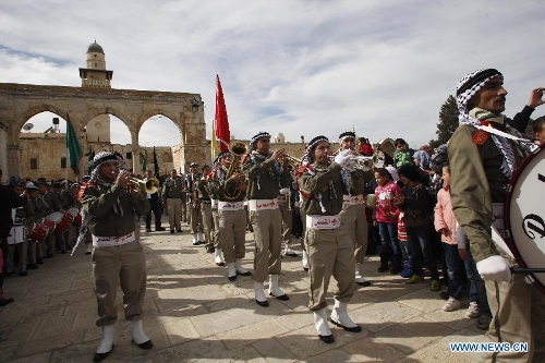 Palestinians take part in a ceremony commemorating the birth of Prophet Mohammed, known in Arabic as 