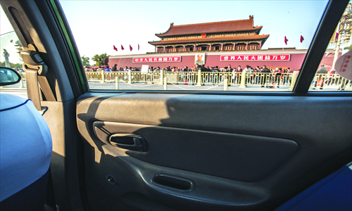 A taxi cab, in which the rear window handles have been removed, drives in front of Tiananmen Sunday.
Photo: Li Hao/GT