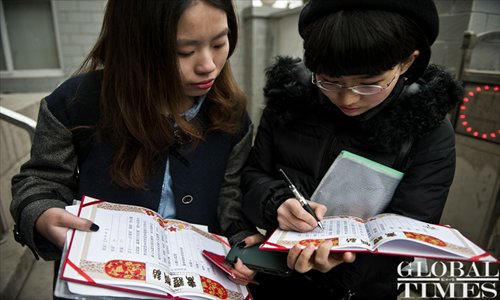 Mayuyu (right) signs her homemade marriage certificate.