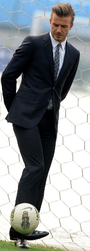 British soccer player David Beckham kicks a ball during his visit to the Beijing Guo'an Soccer Club in Beijing, capital of China, on March 21, 2013. Beckham visited the club as the ambassador for the youth football program in China and the Chinese Super League Thursday. (Xinhua/Gong Lei) 