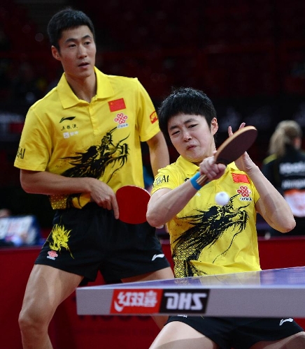 Wang Liqin (L) and Rao Jingwen of China compete during the first round of mixed doubles against Thavisack Phathaphone and Thiphakone Southammavong of Laos at Palais omnisport de Paris Bercy in Paris, France, on May 14, 2013. Wang and Rao won 4-0. (Xinhua/Tao Xiyi)
