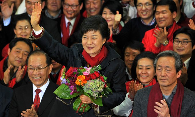 South Korea's presidential candidate Park Geun-Hye of the ruling New Frontier Party, waves after her arrival at the party headquarters in Seoul on Wednesday.  South Korea elected its first female president as national TV predicted a clear victory for conservative Park Geun-Hye, daughter of the country's former dictator. Photo: AFP