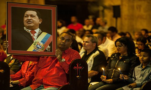 People attend a Catholic mass for the health of Venezuelan President Hugo Chavez in Havana on Saturday. Photo: AFP 