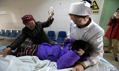 Zhang Jiali, who was injured in a stampede accident that took place at the Qinji Elementary School, receives medical treatment in a hospital in Laohekou City of Xiangyang, central China's Hubei Province, Feb. 27, 2013. Four students were killed in a stampede accident here on Wednesday morning. Relevant departments of Xiangyang have rushed to the scene to carry out rescue efforts, and the injured have been sent to hospital for treatment. The cause of the accident is under investigation. Photo: Xinhua