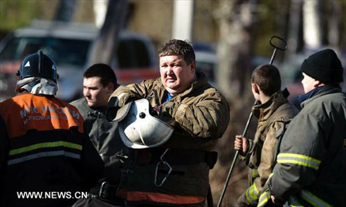 Firefighters are seen at the mental hospital where a fire broke out in Moscow's northern Dmitrovsky district, April 26, 2013.  (Xinhua/Jiang Kehong)