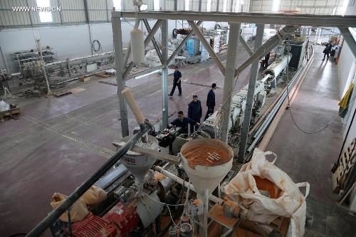 Palestinian workers are seen at the only factory to manufacture sewage pipes at Karni industrial zone in northern Gaza Strip on March 12, 2013. (Xinhua/Wissam Nassar)