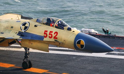 This undated photo shows a carrier-borne J-15 fighter jet landing on China's first aircraft carrier, the Liaoning. China has successfully conducted flight landing on its first aircraft carrier, the Liaoning. After its delivery to the People's Liberation Army (PLA) Navy on Sept. 25, the aircraft carrier has undergone a series of sailing and technological tests, including the flight of the carrier-borne J-15. Capabilities of the carrier platform and the J-15 have been tested, meeting all requirements and achieving good compatibility, the PLA Navy said. Designed by and made in China, the J-15 is able to carry multi-type anti-ship, air-to-air and air-to-ground missiles, as well as precision-guided bombs. The J-15 has comprehensive capabilities comparable to those of the Russian Su-33 jet and the U.S. F-18, military experts estimated. Photo: Xinhua
