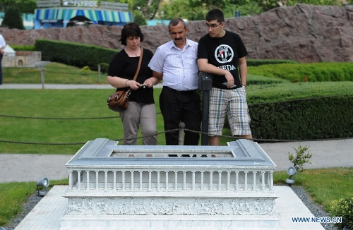 Visitors look at the miniature of Altar of Zeus in the Miniature park in Istanbul, Turkey, on May 11, 2013. The Miniaturk park is the first miniature park in Istanbul and has welcomed 6.5 million visitors over the past 10 years. (Xinhua/Lu Zhe) 