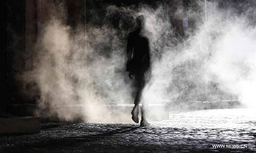 A model displays a creation during SS14 Alexander McQueen Menswear show at the Coal Drops, King's Cross in London, Britain on June 17, 2013. (Xinhua/Wang Lili) 