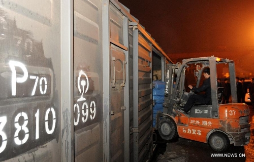 Working staff load the tent toilets into the trains at the Zhengzhou Railway Station in Zhengzhou, capital of central China's Henan Province, April 22, 2013. A total of 200 tent toilets were sent to the earthquake jolted Ya'an City of southwest China's Sichuan Province on Monday. (Xinhua/Li Bo) 