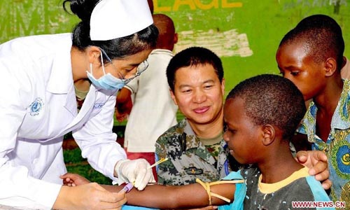 Members of a Chinese peacekeeping medical team conduct health examination for kids in an SOS Children's Village in Bukavu, the Democratic Republic of the Congo, Oct. 1, 2009. Over the two decades since it sent its first peacekeeping troop to Cambodia in April 1992, China has participated in more than 20 UN peacekeeping missions, dispatching a total of 20,000 soldiers. There are now nearly 2,000 Chinese peacekeepers carrying out their tasks in 12 peacekeeping missions. Chinese peacekeeping troops are formed by members of the People's Liberation Army (PLA), which will celebrate its 85th founding anniversary on August 1, 2012. Photo: Xinhua