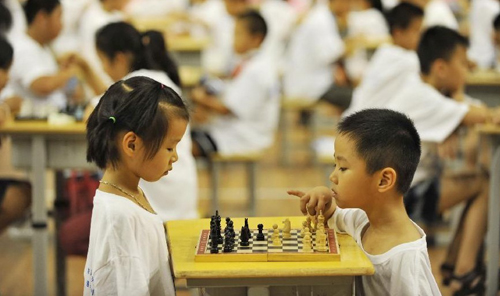 Children play chess, Chinese chess and other mind games in China's Nanchang