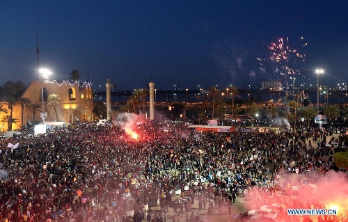 People gather to enjoy the fireworks during a celebration for the second anniversary of the Libyan uprising at the Martyrs' Square in Tripoli on Feb. 17, 2013. (Xinhua/Hamza Turkia) 