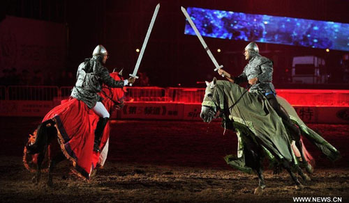 Horsemen stage an equestrian performance at the opening ceremony of the second Ordos Dalate International Horse Culture Festival in Dalate Banner of Ordos, north China's Inner Mongolia Autonomous Region, August 25, 2012. Some 60 horsemen from 15 countries and regions gave performances at the festival's opening ceremony Saturday night. Photo: Xinhua
