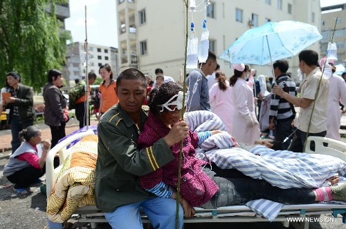 An injured woman receives medical treatment at the People's Hospital in Lushan County of Ya'an City, southwest China's Sichuan Province, April 20, 2013. The death toll rises to 46 in the 7.0-magnitude earthquake hitting Lushan County Saturday morning. (Xinhua/Jiang Hongjing)