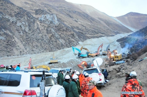 Rescuers work at the accident site after a major landslide hit a mining area of Tibet Huatailong Mining Development Co. Ltd, a subsidiary of the China National Gold Group Corporation, in Maizhokunggar County of Lhasa, capital of southwest China's Tibet Autonomous Region, March 30, 2013. A total of 83 workers were buried in the landslide, which happened on Friday morning. Rescuers have not yet found survivors or bodies 28 hours after the massive landslide. (Xinhua/Zhang Quan) 