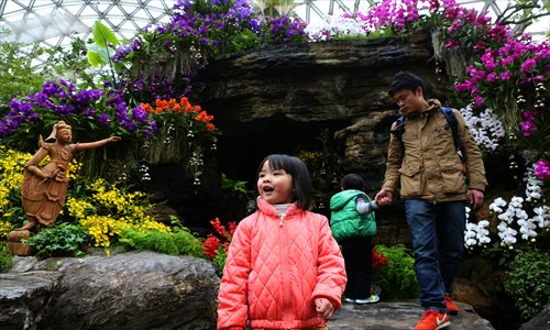 Tourists appreciate the orchids inside one of its greenhouses. 
