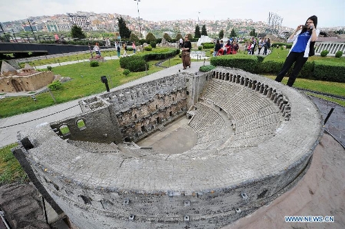 A visitor takes photos in front of the miniature of Alaaddin Mosque in the Miniature park in Istanbul, Turkey, on May 11, 2013. The Miniaturk park is the first miniature park in Istanbul and has welcomed 6.5 million visitors over the past 10 years. (Xinhua/Lu Zhe) 