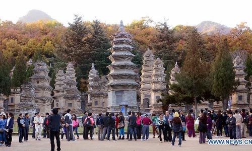 Tourists visit the pagoda forest, tombs of eminent monks of the Shaolin Temple at the foot of the Songshan Mountain in Dengfeng city, Central China's Henan Province, October 31, 2012. Photo: Xinhua
