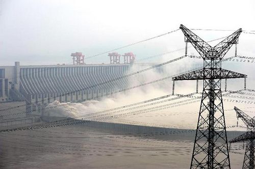Flood water is released from the Three Gorges Dam, a gigantic hydropower project on the Yangtze River, in Yichang city, Central China's Hubei Province, July 24, 2012. Due to the downpours in the upper reaches of the Yangtze River, China's longest, the Three Gorges Dam will experience its largest flood peak this year on Tuesday. Flooding has left more than 700 ships moored on sections of the Yangtze River near the dam since Monday evening. Photo: Xinhua