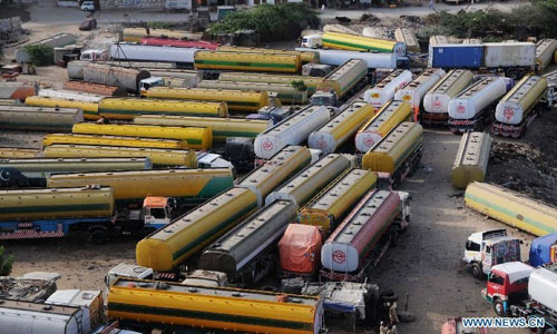 Oil tankers used to transport fuel to NATO forces in Afghanistan are seen at NATO supply terminal in southern Pakistani port city of Karachi, on July 3, 2012. Pakistan on Tuesday night announced that it is reopening land routes for NATO forces in neighboring Afghanistan after US Secretary of State, Hillary Clinton, apologized over the killing of 24 Pakistani soldiers in last November air strike, the country's Information Minister, Qamar-uz-Zaman Kaira said. Photo: Xinhua 