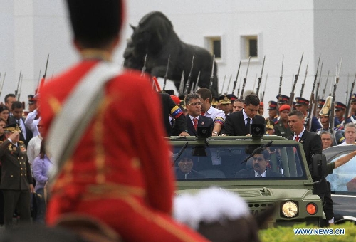 The body of late Venezuelan President Hugo Chavez is carried from the Military Academy to the Mountain Barracks, in the city of Caracas, capital of Venezuela, on March 15, 2013. Venezuelans honored late President Hugo Chavez, before his remains were transfered to the Mountain Barracks, where he will rest inside a glass case. Venezuelan President died on March 5, after struggling with cancer for two years. (Xinhua/AVN) 