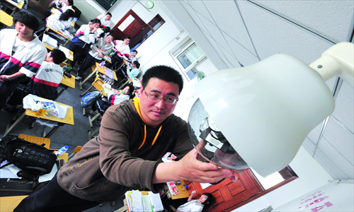 A man installs a camera into a classroom in Beijing. Photo: IC 
